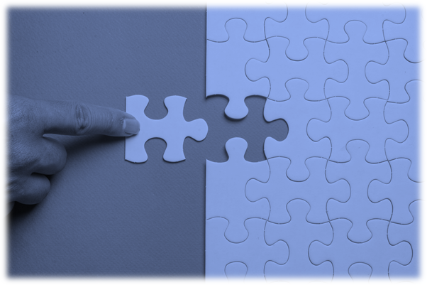 An image in blue tones showing a finger inserting last piece of a puzzle